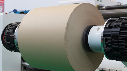Large roll of paper mounted on a winding machine