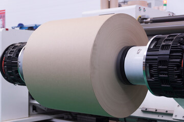 Roll of paper installed in winding machine - obrazy, fototapety, plakaty