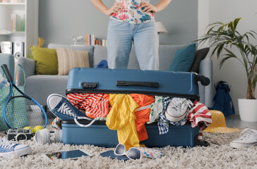 Disappointed woman packing for a journey
