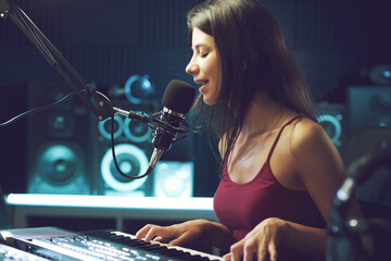 Young female artist working in the recording studio