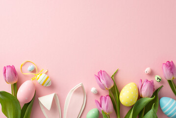 Easter-themed composition showcasing lively eggs, an endearing bunny ears, and tulips. Top view on a pastel pink background, ready for your text or promotional content
