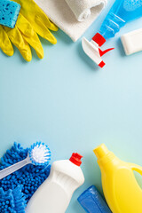 A clean sweep in aesthetics. Top view vertical photo featuring cleaning essentials—rags, gloves,...