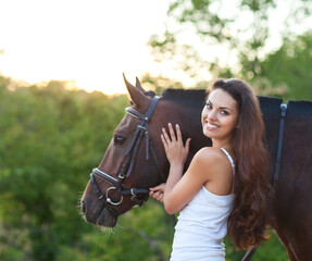 Portrait beautiful woman with long hair next horse