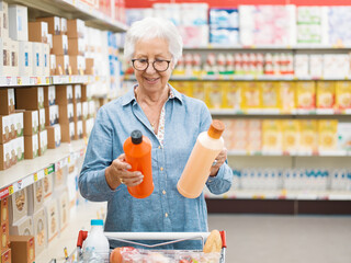 Senior customer comparing products at the supermarket