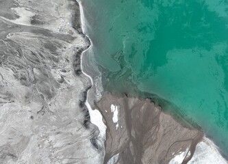  aerial view of green or turquoise polluted water with dirt flowing into a lake from a thermal plant or chemical industry factory
