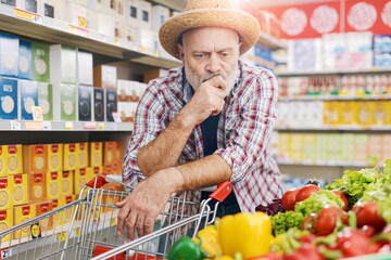 Picky farmer buying vegetables at the grocery store