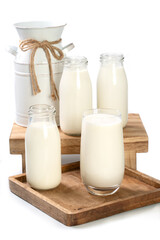  Bottles of milk and pitcher on white background