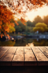 Empty blank wooden table fall background with autumn trees orange yellow color leaves backdrop forest or park nature scene abstract blurred bokeh tabletop for product display desk mockup. Copy space.