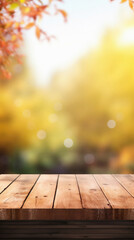 Empty blank wooden table fall background with autumn trees orange yellow color leaves backdrop forest or park nature scene abstract blurred bokeh tabletop for product display desk mockup. Copy space.