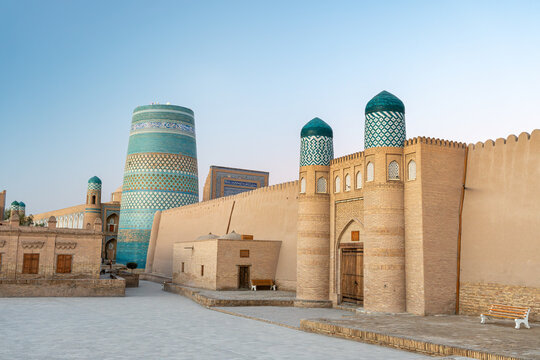 View to the unfinished Kalta Minor Minaret with Blue Mosaic Walls, which is built by Mohammed Amin Khan, in Khiva, Uzbekistan. empty streets of the ancient city of the Khorezm kingdom during the day.