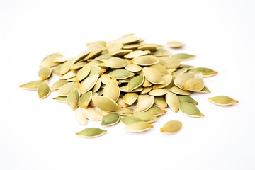 heap of raw pumpkin seeds on white background
