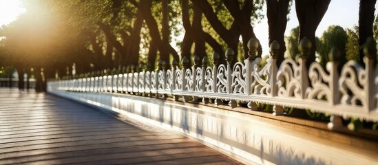 Park Elegance A scenic landscape featuring a white balustrade bathed in the warm hues of the setting sun - obrazy, fototapety, plakaty