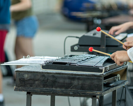 flashing mallets of the sideline percussionists at rehearsal