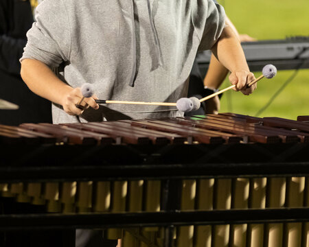 flashing mallets of the sideline percussionists at rehearsal