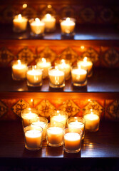 Burning small candles in glasses, romantic decoration in vintage style, selective focus