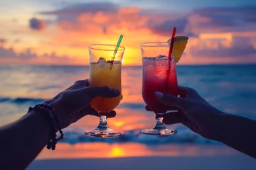 Foto auf Acrylglas Two people toasting cocktails at the beach during sunset close-up, summer vacation enjoyment © Dennis