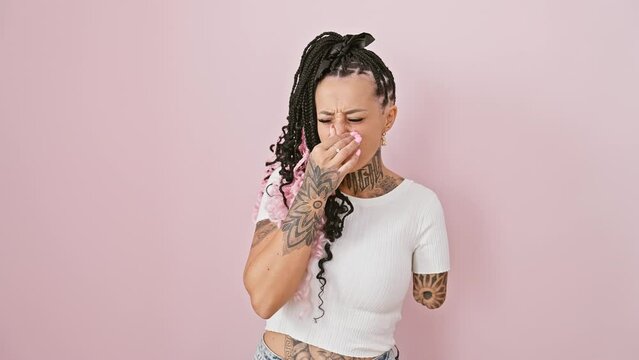 Woman amputee, hispanic standoff over stinky, intolerable stench! disgusting bad smell sends shockwaves, as she holds nose in breath-halted disgust against isolated pink background