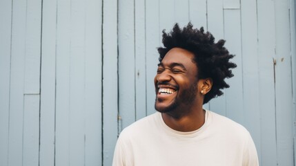 Carefree Black Man Laughing Against White Wall - obrazy, fototapety, plakaty