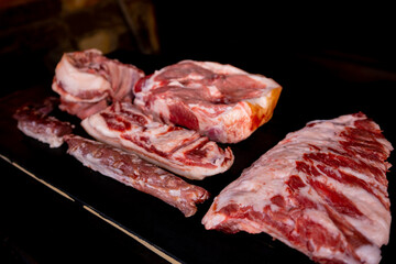 Different types of raw meat with fresh herbs.