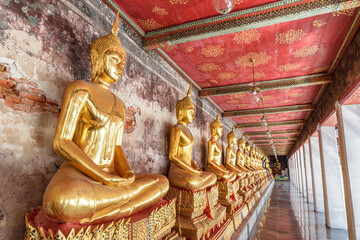 Row of gilded Buddha statues in Wat Suthat Thepwararam, Bangkok - obrazy, fototapety, plakaty