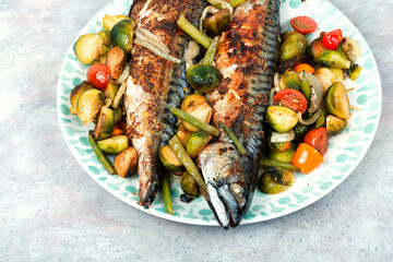 Grilled mackerel fish with vegetables.