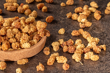 Ripe mulberry fruits on dark background, delicious food picture for culinary design