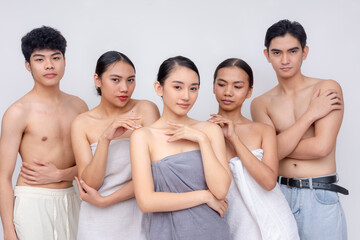 Group of sexy young adults, 3 women wrapped in towels and 2 half naked men with neutral...