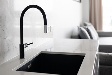Black tap mixer white stone benchtop kitchen home loungeroom window simple modern