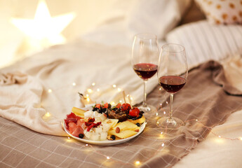 Wine and food on bed
