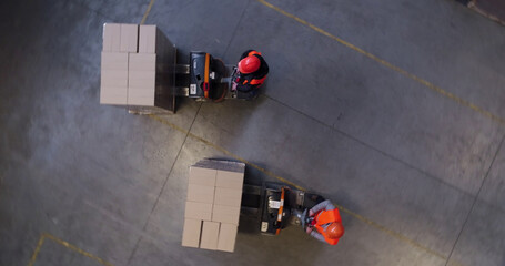 High angle view of a forklift carrying cardboard boxes in a warehouse