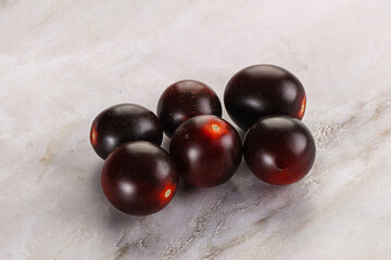 Raw ripe black kumato tomato