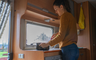 Woman cooking inside a motorhome