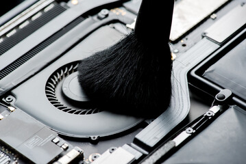Cleaning and repairing the interior of a laptop.