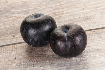 Two ripe sweet black plums