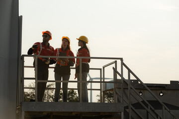 A group of engineers and architects work in floor of base ground of a wind turbine