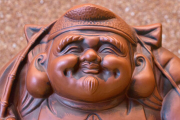 Face of Japanese fortune god statue.