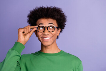 Photo of positive good mood guy wear green pullover arm hand eyeglasses looking empty space isolated purple color background