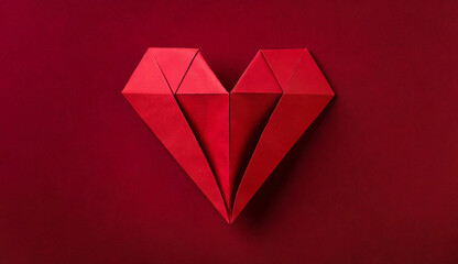 Red origami paper heart on dark red background