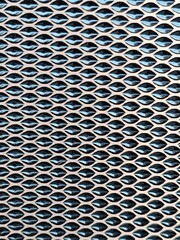 A close up view of a metal grill reveals intricate patterns, sharp edges, and a sturdy construction that exudes strength.