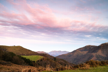 Landscape of the Basque Country with mountains and the Rhune mountain in the background. Golden hour and pink clouds. Spain. - 713122767