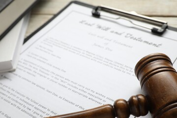Last Will and Testament, books and gavel on white table, closeup
