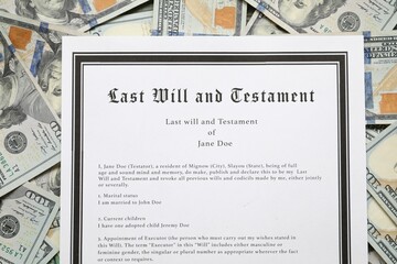 Last Will and Testament on dollar bills, top view