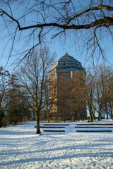 Hamburg in winter, Park around an ancient water tower in Sunny frosty day. Vertical frame . High quality photo