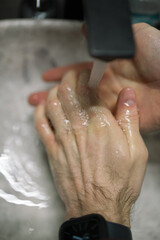 Fototapeta premium A man is washing hands