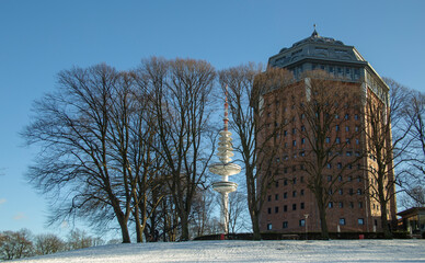Hamburg in winter, Park around an ancient water tower in Sunny frosty day with a television tower...