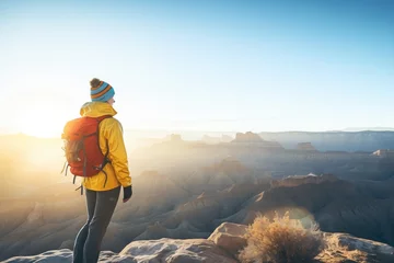 Poster hiker overlooking a vast canyon at sunrise © Natalia