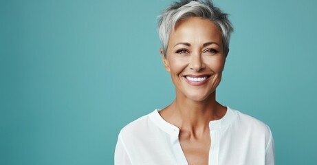 Joyful middle-aged woman radiating beauty with healthy skin and a bright smile - obrazy, fototapety, plakaty