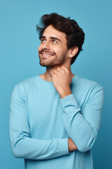 Obraz premium Man thinking about his inspiration touch chin looking mockup choosing product option isolated on blue color background