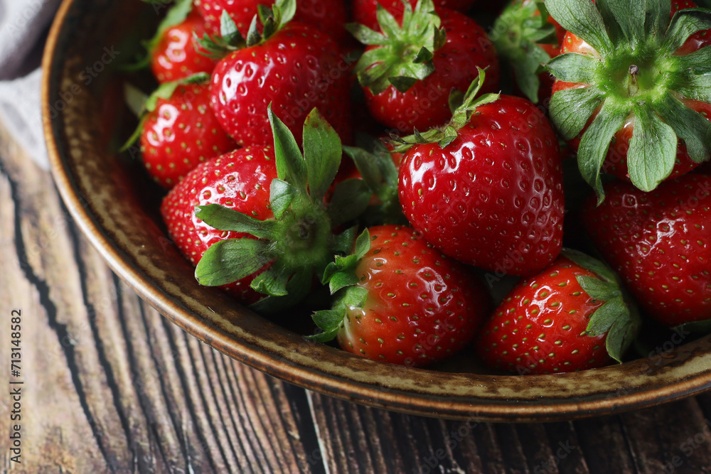 Wall mural A bowl with ripe bright strawberry in rustic style