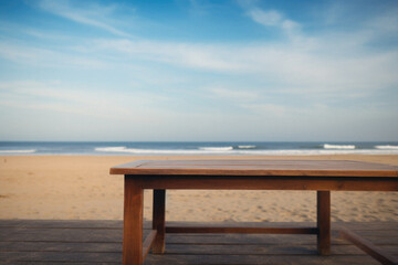 Fototapeta na wymiar Wooden table ocean bokeh background, empty wood desk surface product display mockup with blurry sea water sunny beach abstract summer travel backdrop advertising presentation. Mock up, copy space.